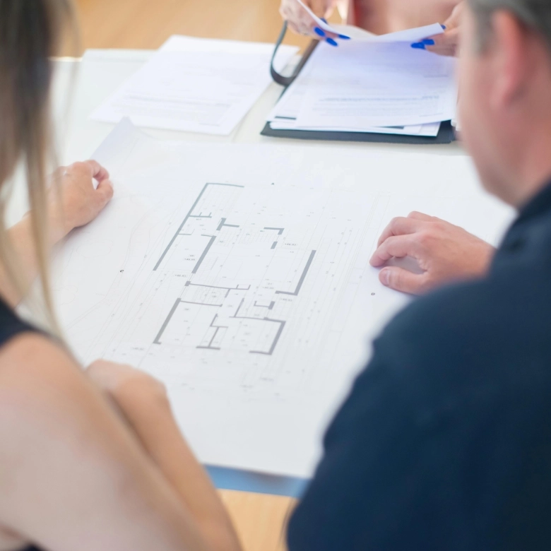 Worker Standing Between Solar Panels